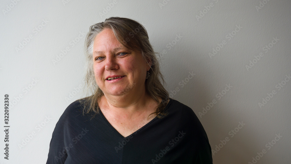 Happy old woman with green eyes smiling at camera. Beautfiul green eyed elderly woman with happiness concept. Pleasant lady isolated on white wall background. Happy old woman with green eyes smiling at camera. Beautfiul green eyed elderly woman with happiness concept. Pleasant lady isolated on white wall background.