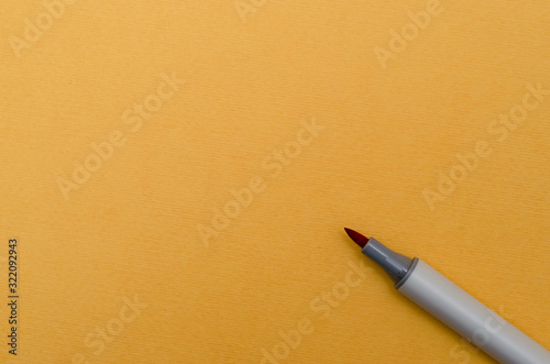 Color marker on blank yellow textured paper. Place for text. 