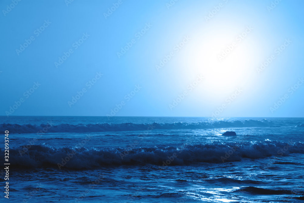 Beautiful seascape with the sunset in the trendy classic blue color of the year.