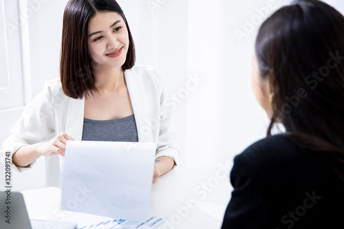 Businesswoman consulting financial advisor. Business professional studying documents and talking to colleague. Consulting concept.