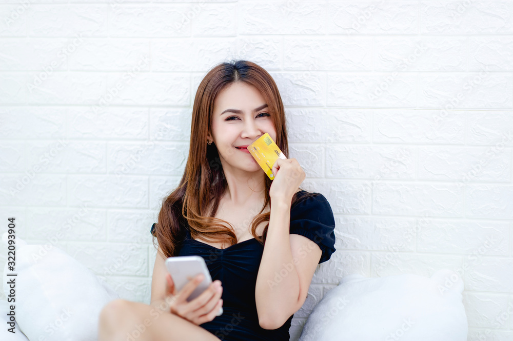 Woman and credit card business women talk on the phone and look at the credit card Business idea Woman and credit card business women talk on the phone and look at the credit card Business idea