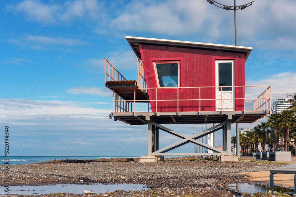 Red lifeguard rescue tower on the beach
