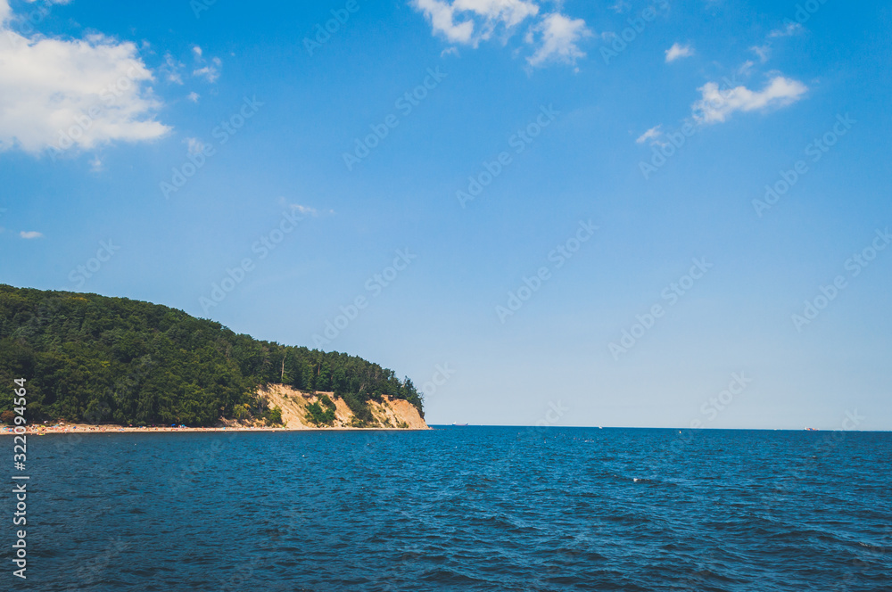 Spectacular view on the island in the sea covered with forest and yellow sand