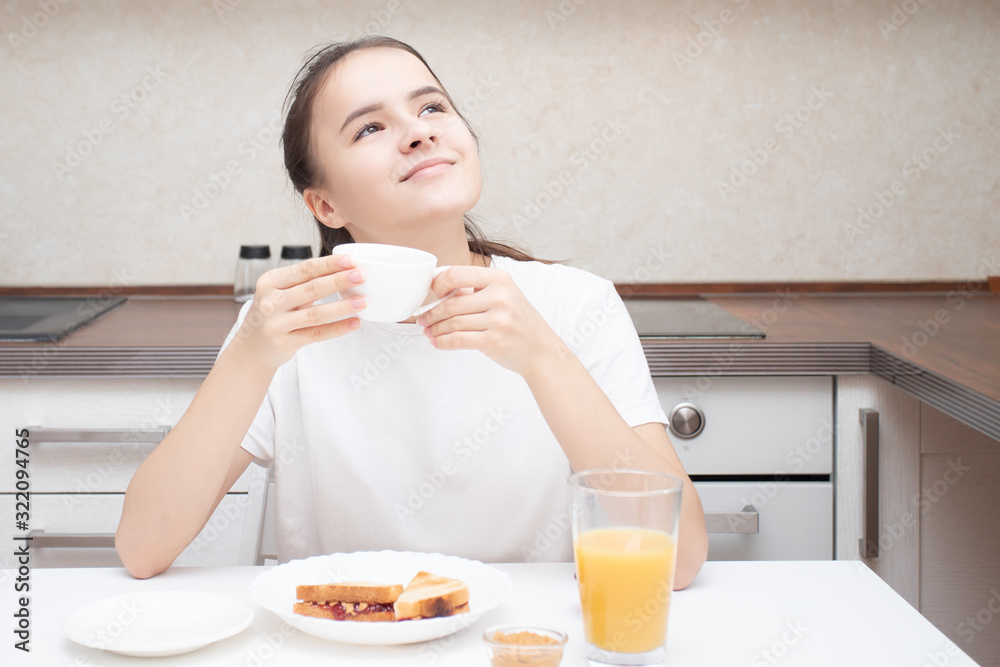 Beautiful european girl drinks aromatic coffee for breakfast Beautiful european girl drinks aromatic coffee for breakfast