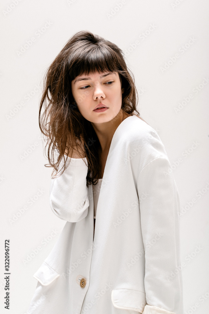 Fashion trendy style portrait photo of a young woman female model clear skin in studio white backgound Fashion trendy style portrait photo of a young woman female model clear skin in studio white backgound
