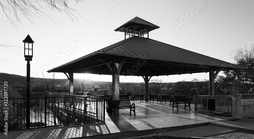 Boardwalk and gazebo overlooking the Guadalupe River in Kerrville Texas  in black and white at sunset photo