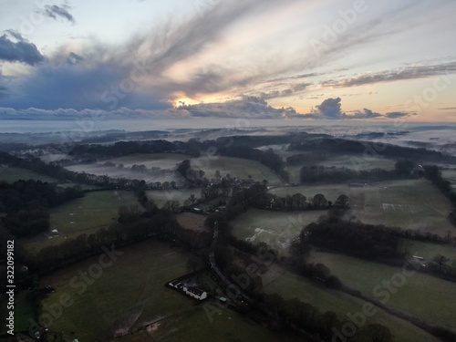 An aerial view of fields and the hedges on a misty evening © chris