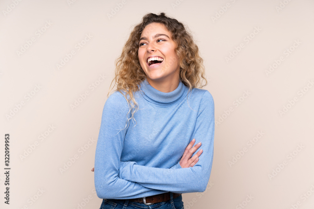 Young blonde woman with curly hair wearing a turtleneck sweater ...