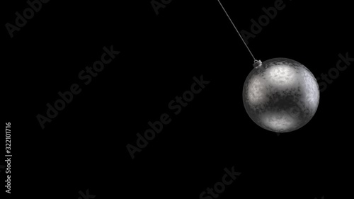 loop able swinging Black metal wrecking ball with white alpha mask channel on black background. S&M object concept. photo