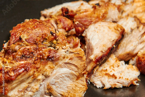 baked meat cut into pieces close up photo
