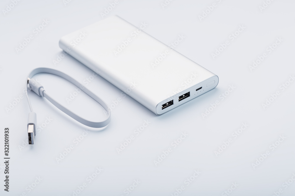 Powerbank for charging mobile devices with cable, on a white background.