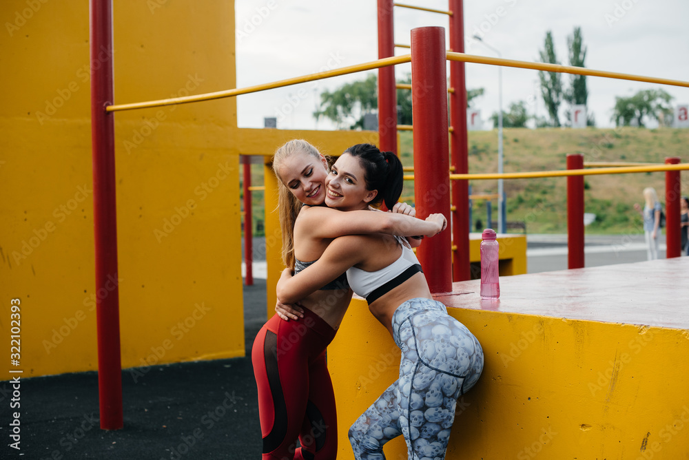 Obraz premium Athletic, sexy girls play sports in the open air. Fitness, healthy lifestyle