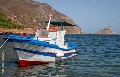 A fishing boat anchored on the shore in the small port of the island of Marettimo, in the Egadi islands in Sicily, Italy.
