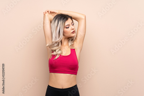 Teenager sport girl over isolated background stretching © luismolinero