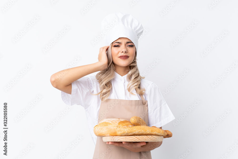 Teenager girl in chef uniform. Female baker holding a table with several breads over isolated white background unhappy and frustrated with something. Negative facial expression Teenager girl in chef uniform. Female baker holding a table with several breads over isolated white background unhappy and frustrated with something. Negative facial expression