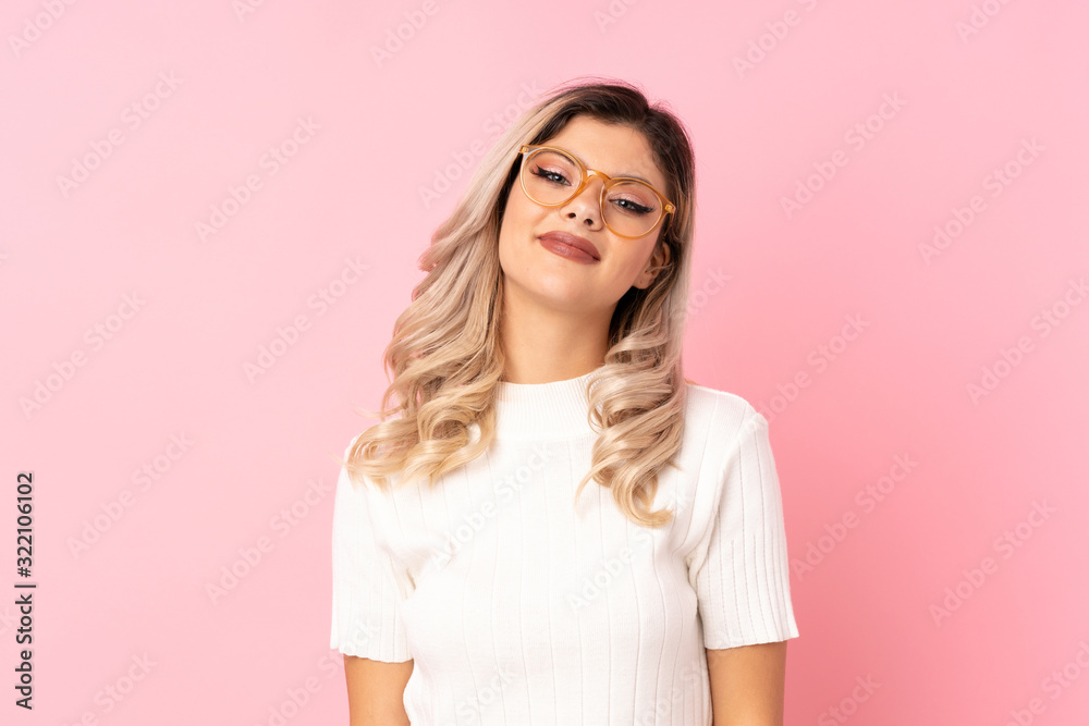 Teenager girl over isolated pink background with glasses Teenager girl over isolated pink background with glasses