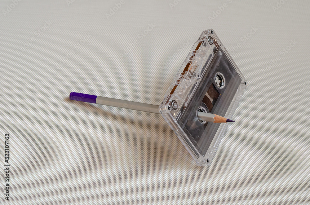 Old audio cassette with tape and pencil. Used a pencil