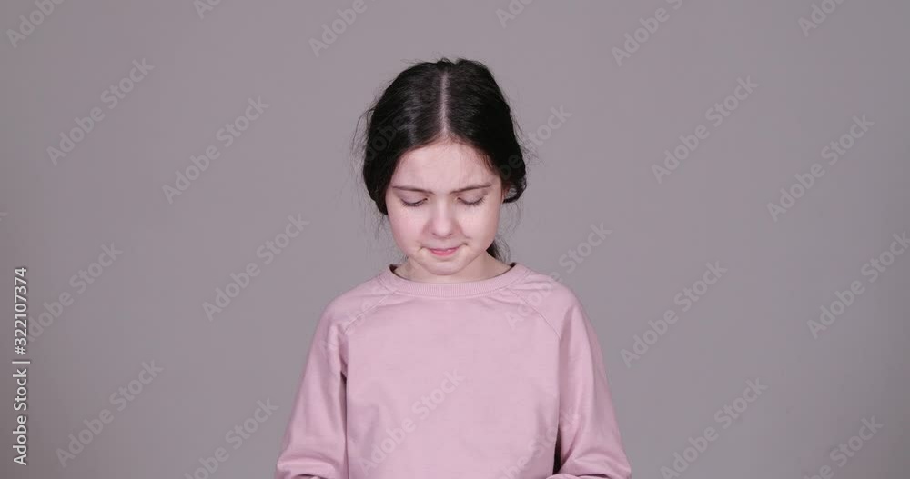 Little girl suffering from cold on grey background Little girl suffering from cold on grey background