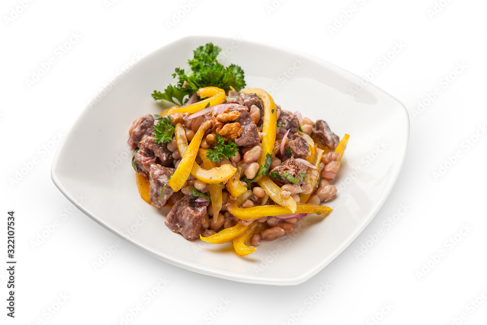 stew of white beans and bell yellow pepper with beef meat closeup with ingredients. On a white plate, isolated