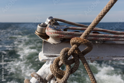 Yacht ropes and cables. Nautical knots and ropes on the yacht. Yacht accessories on the sea background