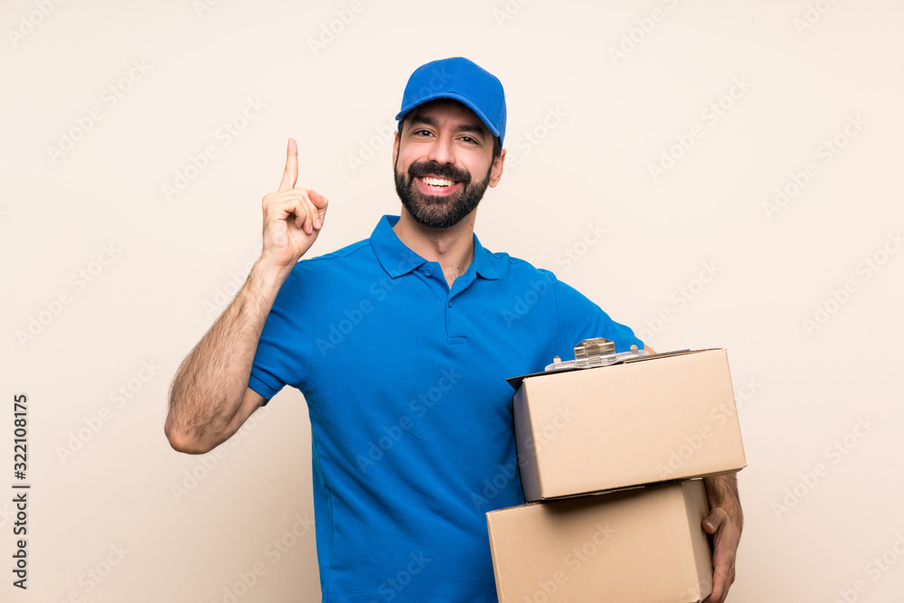 Delivery man with beard over isolated background pointing up a great idea Delivery man with beard over isolated background pointing up a great idea