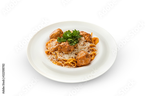  Spaghetti with meatballs, parmesan and tomato sauce on a plate. Tasty Italian pasta food. Top view shot above isolated on white background.