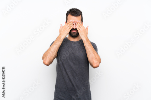 Young handsome man over isolated white background covering eyes by hands