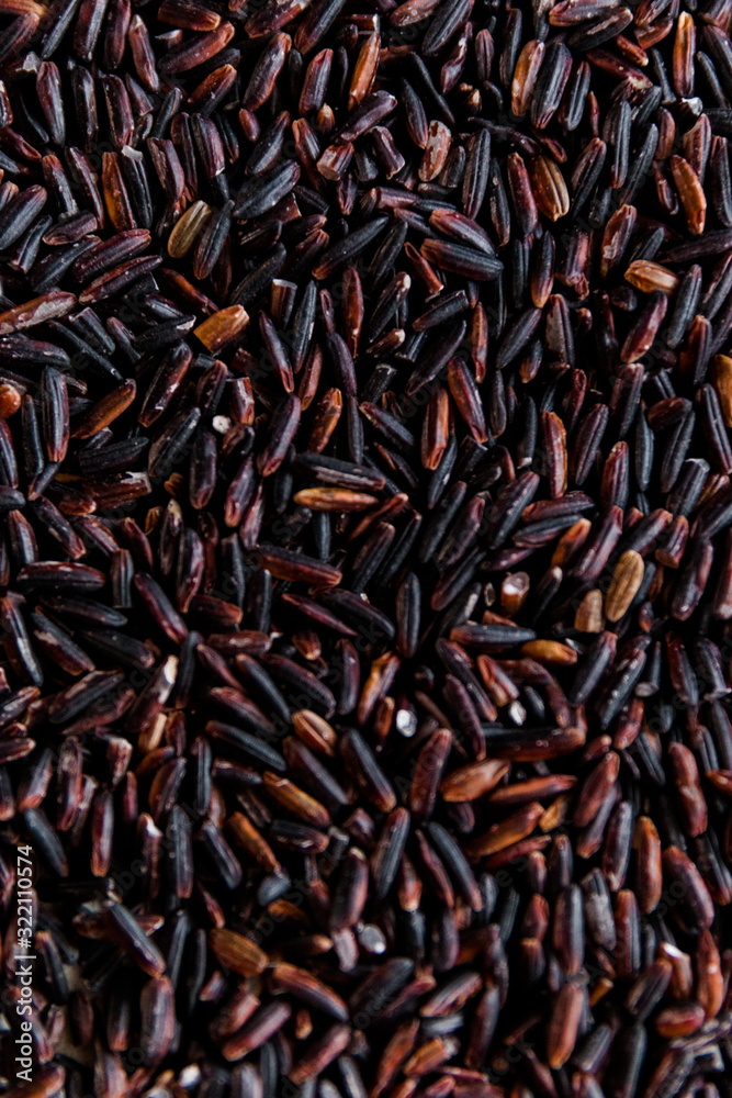 Black wild rice close-up background texture top view, selective focus