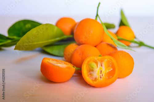 Calamondins on white cutting board photo