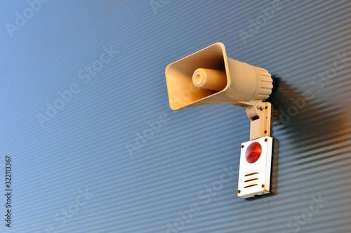Megaphone for signaling in case of fire on the wall of a warehouse building.