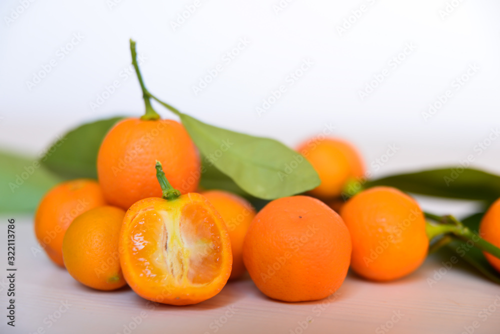 Calamondins on white cutting board Calamondins on white cutting board