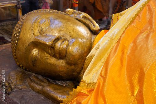 The Reclining Buddha Statue (The Death of  Gautama Buddha ) in Parinirvana  Stupa in Kushinagar, India photo