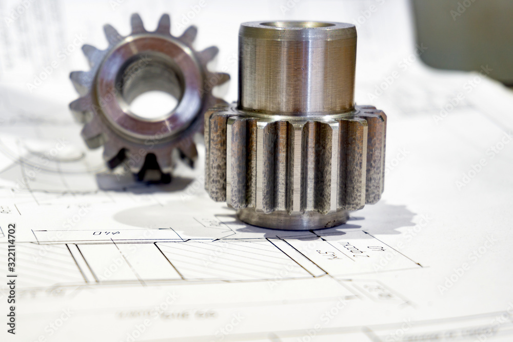 The gear after manufacturing on the gear cutter lies on the technical drawing. The gear after manufacturing on the gear cutter lies on the technical drawing.