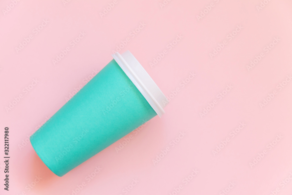 Fototapeta premium Simply flat lay design blue paper coffee cup on pink pastel colorful trendy background. Takeaway drink container. Good morning wake up awake concept. Template of drink mockup. Top view copy space