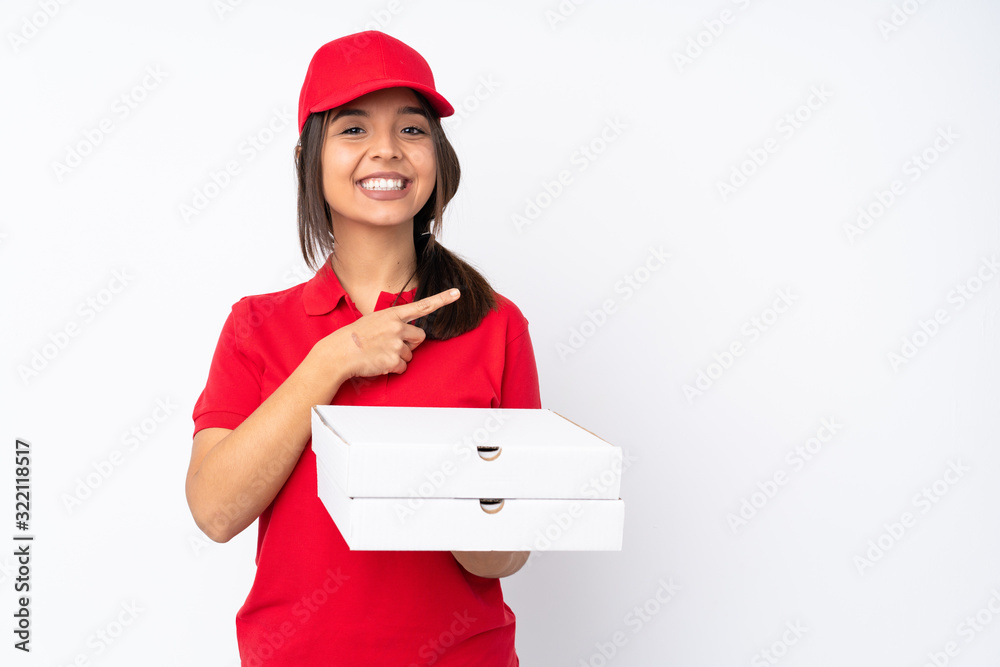 Young Pizza delivery girl over isolated white background pointing to the side to present a product Young Pizza delivery girl over isolated white background pointing to the side to present a product