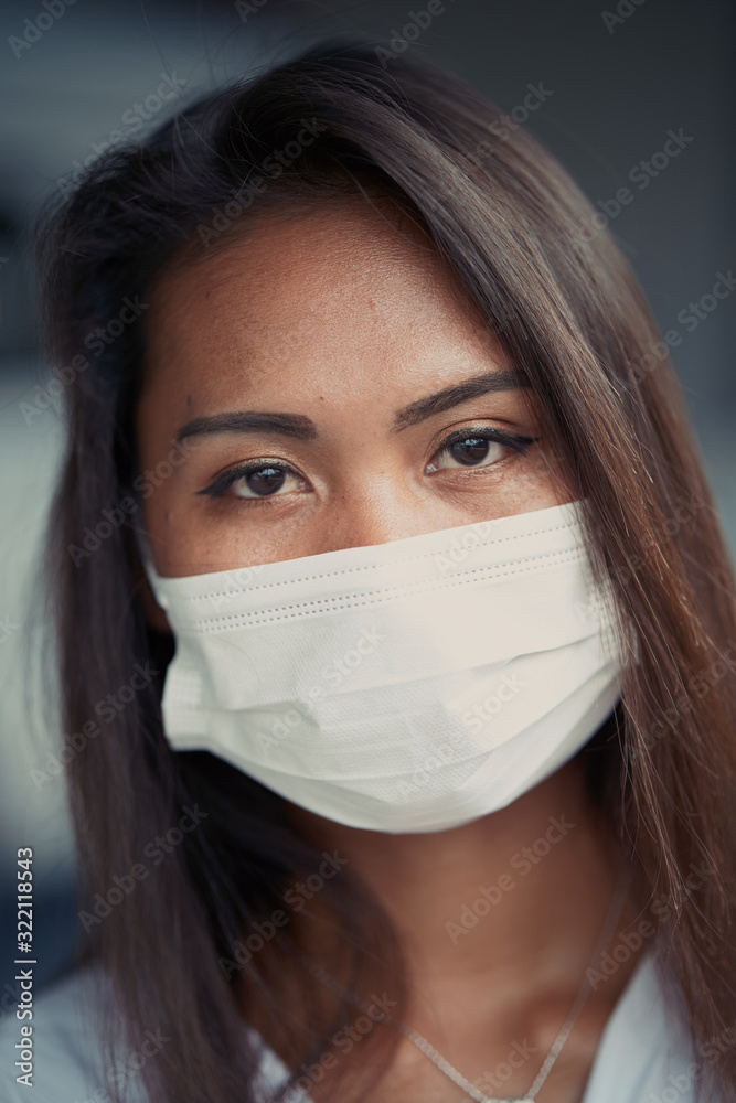 young beautiful Asian woman or hospital nurse using protective medical face mask in prevention vs virus infection. Coronavirus outbreak in China young beautiful Asian woman or hospital nurse using protective medical face mask in prevention vs virus infection. Coronavirus outbreak in China