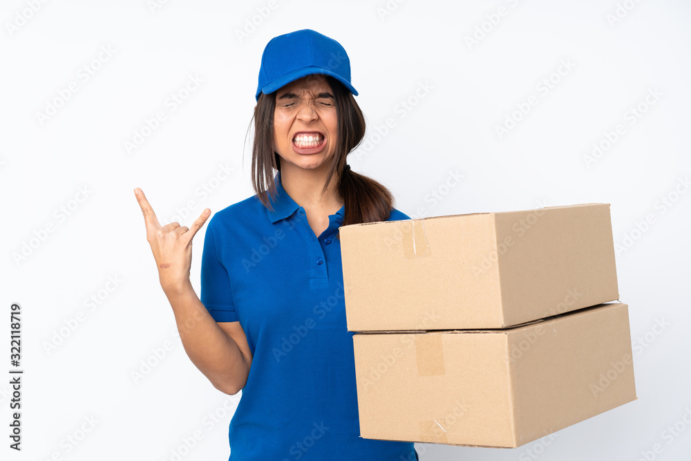 Young delivery brunette girl over isolated white background making rock gesture Young delivery brunette girl over isolated white background making rock gesture