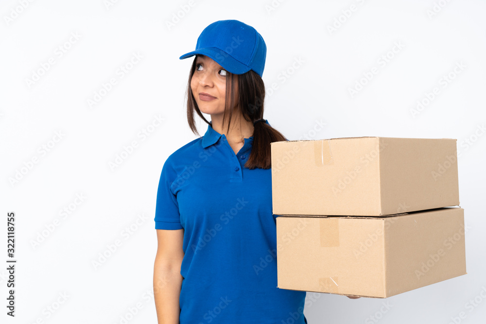 Young delivery brunette girl over isolated white background making doubts gesture looking side Young delivery brunette girl over isolated white background making doubts gesture looking side