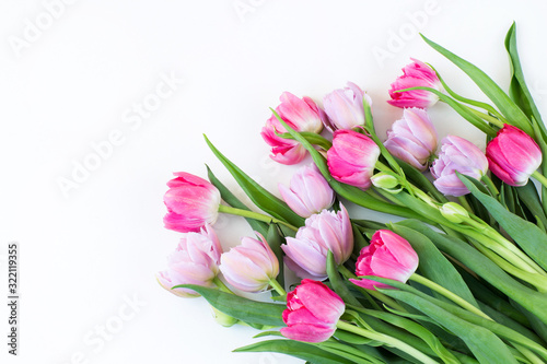 on a white background a bouquet of pink and purple tulips and free space for text