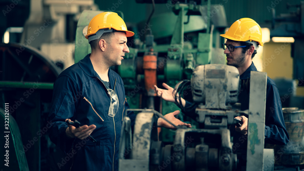 Scene shot of 2 industrial workers feeling upset with the engine machine of the factory, arguing planning, the procedure of work in the factory, concept industrial worker life, working confliction. Scene shot of 2 industrial workers feeling upset with the engine machine of the factory, arguing planning, the procedure of work in the factory, concept industrial worker life, working confliction.