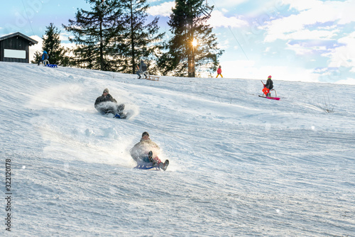 There is a toboggan lift in the winter sports area. Winter fun for families in the sunshine. photo