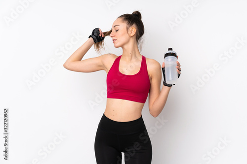 Young sport brunette woman over isolated white background with sports water bottle