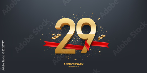 29th Year anniversary celebration background. 3D Golden number wrapped with red ribbon and confetti on black background. photo