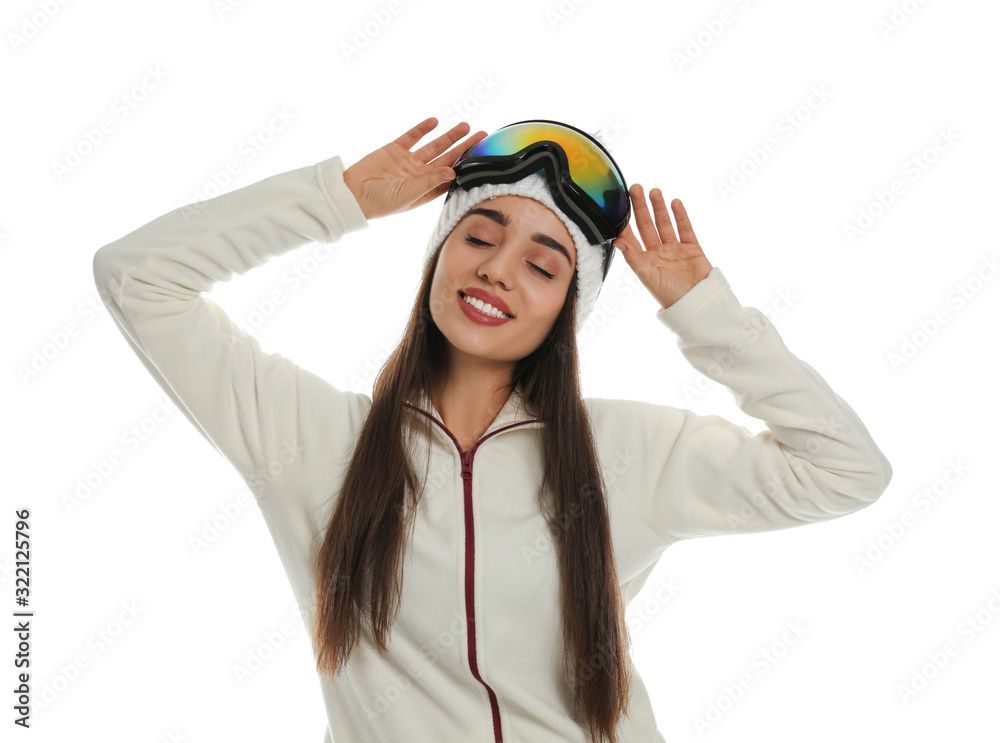 Woman wearing fleece jacket, hat and goggles on white background. Winter sport clothes