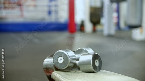 Man takes two dumbbells 6kg in the gym photo