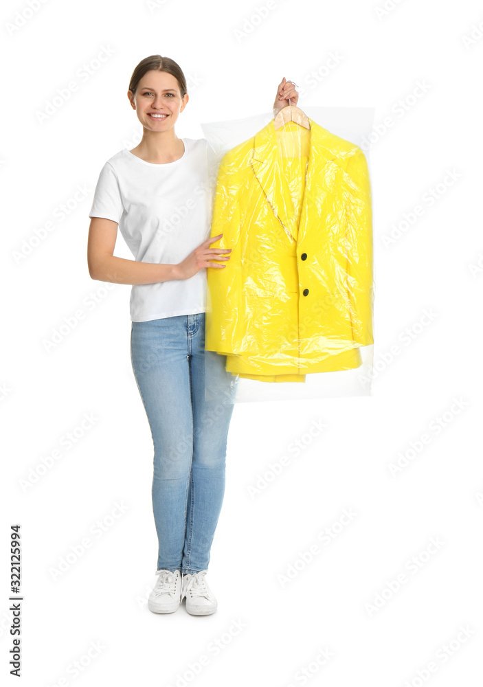 Young woman holding hanger with jacket in plastic bag on white background. Dry-cleaning service Young woman holding hanger with jacket in plastic bag on white background. Dry-cleaning service