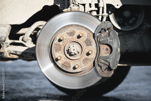 Wheel hub closeup. Jacked car with unscrewed wheel close up. © Dmitriy