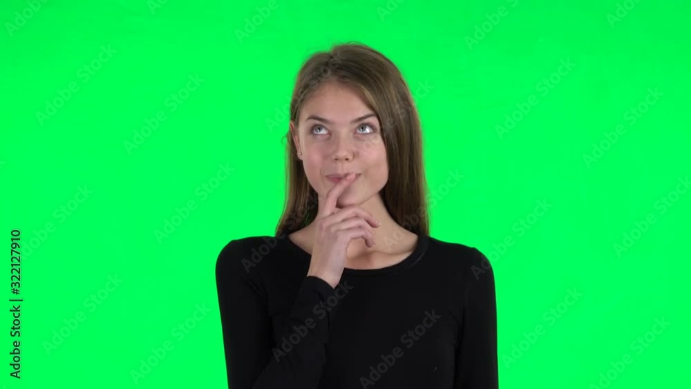 Young woman daydreaming and smiling looking up. Green screen Young woman daydreaming and smiling looking up. Green screen