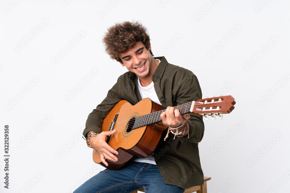 Young caucasian man with guitar over isolated white background Young caucasian man with guitar over isolated white background