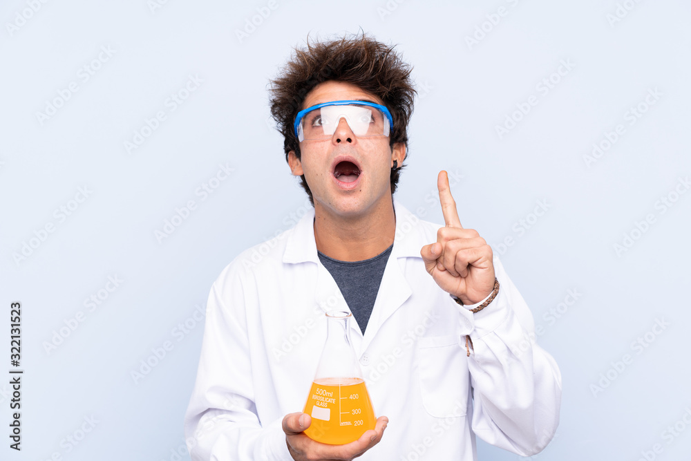 Young scientific man over isolated blue background pointing with the index finger a great idea Young scientific man over isolated blue background pointing with the index finger a great idea